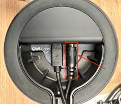 An image of the bottom of a OWL 360 conference room camera, with a box and an arrow highlighting the power cable